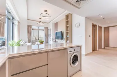 a laundry room with a washer and dryer at Full Burj Khalifa and Dubai Canal views, Minutes from Downtown and Dubai Mall - Farhad Azizi Residence, Al Jaddaf by Deluxe Holiday Homes in Dubai