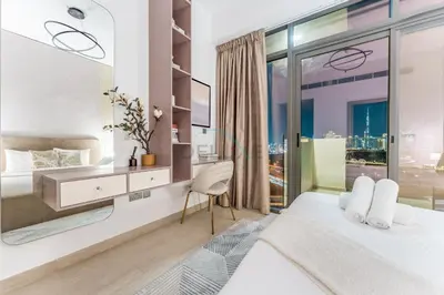 a bedroom with a bed and a large window at Full Burj Khalifa and Dubai Canal views, Minutes from Downtown and Dubai Mall - Farhad Azizi Residence, Al Jaddaf by Deluxe Holiday Homes in Dubai