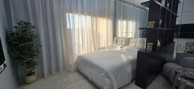 a bedroom with a bed and a large window at Peaceful Apartments in Dubai