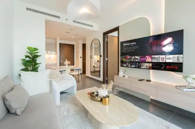 a living room with a large flat screen tv at Luxury 1BR Apartment - Pool View - The Crest Dubai in Dubai