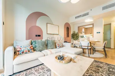 a living room with a white couch and a table at Walk from Burj Khalifa and Dubai Mall, and Conveniently Located near the Metro Station - BD Standpoint A, Downtown by Deluxe Holiday Homes in Dubai