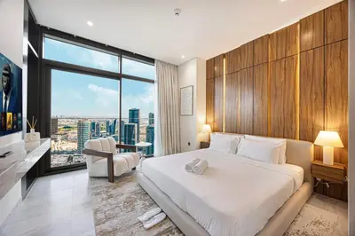 a bedroom with a large bed and a large window at 833keys - 1BR - Waterfront Stay - Business Bay in Dubai