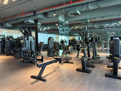 a gym with a lot of treadmills and machines at Sterling West House in Dubai