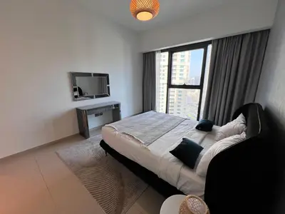 a bedroom with a large bed and a television at Act Tower 410 in Dubai