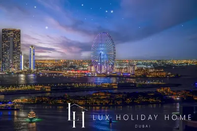 a city skyline with a ferris wheel at night at LUX Iconic Views at The Palm Tower Studio 4 in Dubai