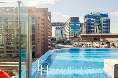 a swimming pool on top of a building with buildings at LUX Iconic Views at The Palm Tower Studio 4 in Dubai
