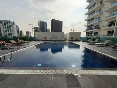 a large swimming pool on the roof of a building at Canal View Studio AG Tower in Dubai