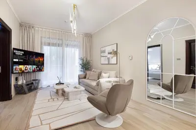 a living room with a couch and a mirror at Luxury Old Town Yansson Downtown Dubai Apartment Pool Burj Khalifa Views Steps to Dubai Mall by La Brisa in Dubai