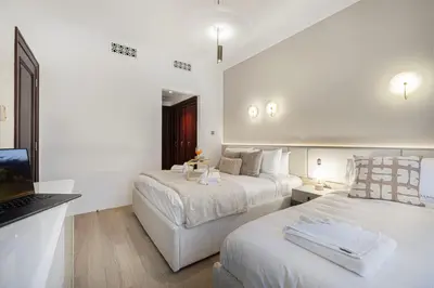 a hotel room with two beds and a television at Luxury Old Town Yansson Downtown Dubai Apartment Pool Burj Khalifa Views Steps to Dubai Mall by La Brisa in Dubai