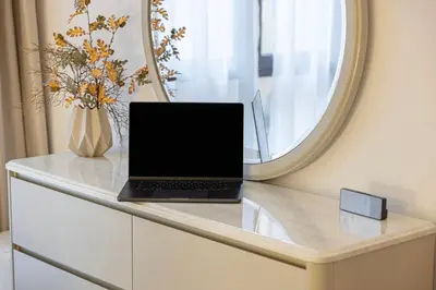 a laptop sitting on a counter with a mirror at Luxury Old Town Yansson Downtown Dubai Apartment Pool Burj Khalifa Views Steps to Dubai Mall by La Brisa in Dubai