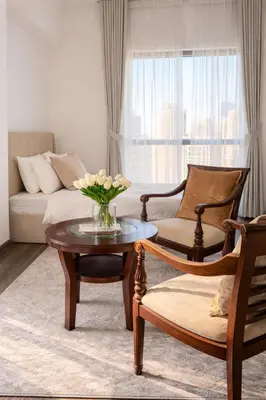 a living room with a couch and a table and chairs at Lux 4BR JBR I Sea View I Walk to Beach I Sleeps 12 in Dubai
