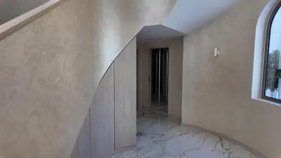 a hallway of a house with a staircase and a window at World Class 6 BDR Villa In Signature Palm in Dubai