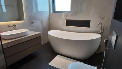 a white bathroom with a tub and a sink at World Class 6 BDR Villa In Signature Palm in Dubai