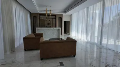 a living room with two chairs and a table at World Class 6 BDR Villa In Signature Palm in Dubai