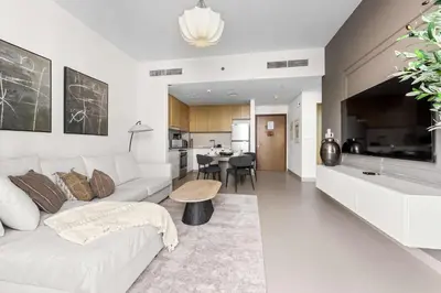 a living room with a white couch and a table at StayShort - Luxury 1 Bedroom Apartment in Dubai Marina Sleeps 4 in Dubai