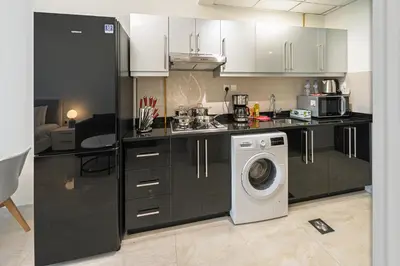 a kitchen with a washer and a washing machine at Chic Studio Canal Side Speedy wi-fi BBay in Dubai