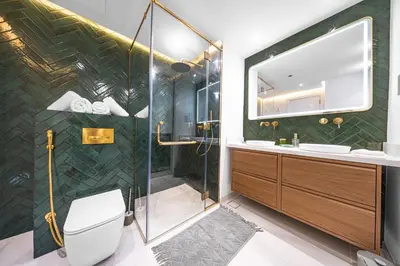 a bathroom with a shower and a toilet and a sink at Emerald Luxury Suite DMCC Metro station in Dubai