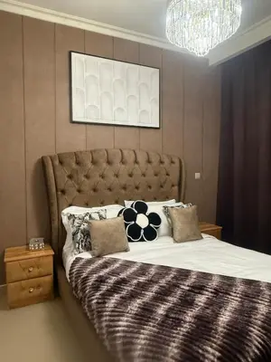 a bedroom with a large bed and a chandelier at Central Downtown 1BR - Walk to Dubai Mall in Dubai