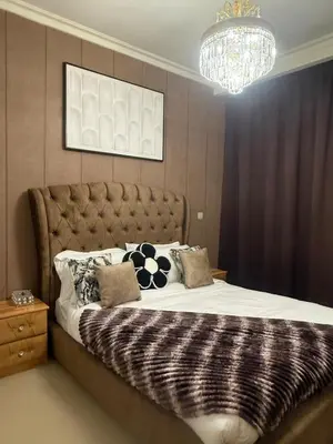 a bedroom with a large bed with a chandelier at Central Downtown 1BR - Walk to Dubai Mall in Dubai