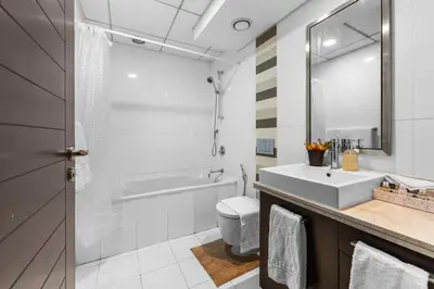a bathroom with a sink and a toilet and a mirror at Downtown Dubai 1BR - 2BR Full Burj Khalifa View in Dubai