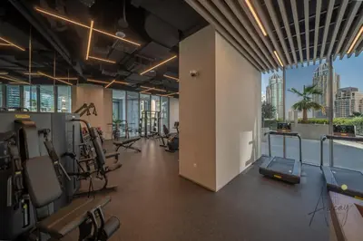 a gym with cardio equipment and a view of the city at Luxe 2BR Maid High Floor LIV Marina Dream in Dubai
