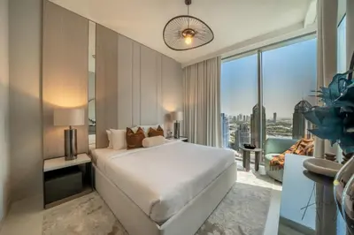 a bedroom with a white bed and a large window at Luxe 2BR Maid High Floor LIV Marina Dream in Dubai