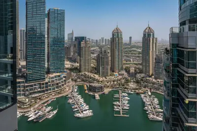 a group of boats in a harbor in a city at Luxe 2BR Maid High Floor LIV Marina Dream in Dubai