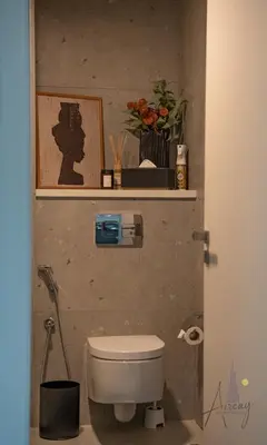 a bathroom with a toilet and a picture on the wall at Luxury Modern 1BR Paragon by Igo Downtown 1BR in Dubai