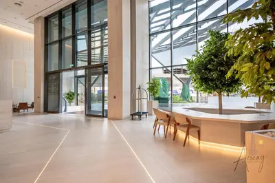 an office lobby with chairs and a large window at Luxury Modern 1BR Paragon by Igo Downtown 1BR in Dubai