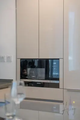 a kitchen with a microwave in a white cabinet at Luxury 1BR Paragon by IGO BURJ khalifa View in Dubai