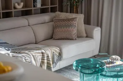a living room with a couch and a glass table at Luxe Missoni-Inspired 1BR Sky-High Living in Dubai