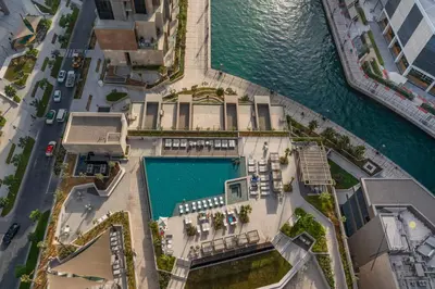 an overhead view of a pool next to the water at Luxe Missoni-Inspired 1BR Sky-High Living in Dubai