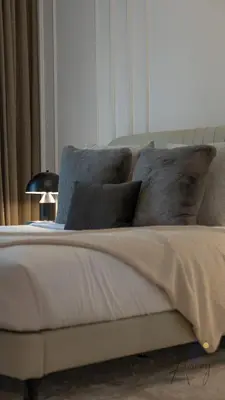 a bed with pillows and a lamp in a bedroom at Upscale 1BR Paragon by IGO Near Downtown in Dubai
