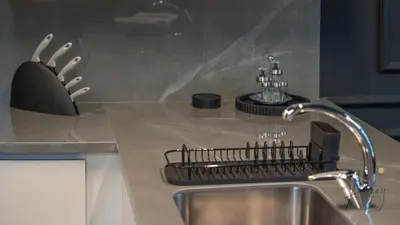 a kitchen counter with a sink and a faucet at Upscale 1BR Paragon by IGO Near Downtown in Dubai
