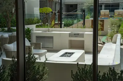 a kitchen with a sink and a table at Urban Oasis 1BR Designer Nest Chic & Cosy in Dubai