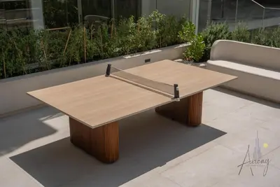 a wooden coffee table on a patio with a couch at Boutique 1BR Escape Cosy & Classy JVC in Dubai