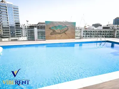 a large swimming pool on the roof of a building at Supreme joy in Arjan 1 BHK in Dubai