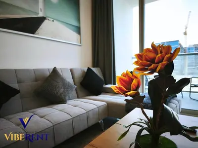 a living room with a couch and a table at Supreme joy in Arjan 1 BHK in Dubai