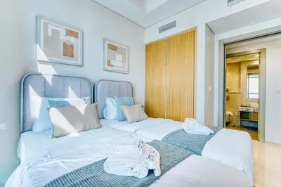 a bedroom with two beds with towels on them at PVH - City View Contemporary 2BR - Aykon Tower C in Dubai