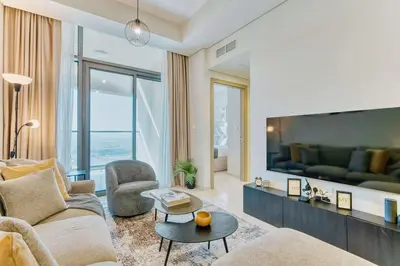 a living room with a couch and a tv at PVH - City View Contemporary 2BR - Aykon Tower C in Dubai