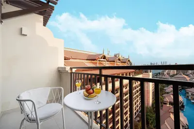 a balcony with a table and a glass of wine at Luxe Royal Amwaj Palm Jumeirah Beach Access in Dubai