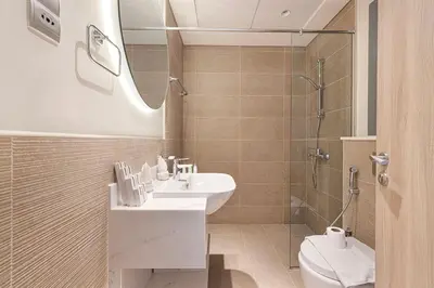a bathroom with a sink and a shower and a toilet at Swanky Studio with Balcony in Dubai Hills Estate in Dubai