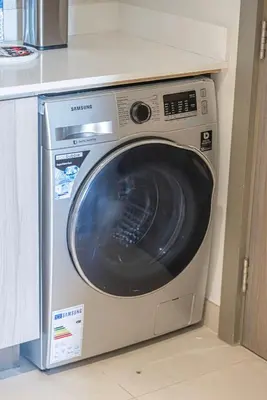 a washing machine is sitting in a kitchen at Swanky Studio with Balcony in Dubai Hills Estate in Dubai