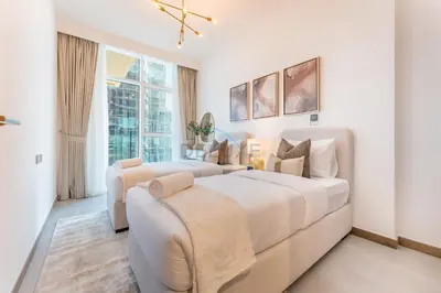 a white bedroom with a large bed and a window at Balcony Facing a Partial Canal View, Close to Metro and Marine Transport, Downtown Attractions Just a Ride Away, Urban Oasis, Business Bay by Deluxe Holiday Homes in Dubai