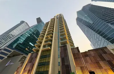 a group of tall buildings in a city at Balcony Facing a Partial Canal View, Close to Metro and Marine Transport, Downtown Attractions Just a Ride Away, Urban Oasis, Business Bay by Deluxe Holiday Homes in Dubai