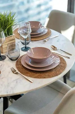 a table with plates and silverware on top of it at Modern 1BR in Dubai Marina near to Dubai Harbour in Dubai