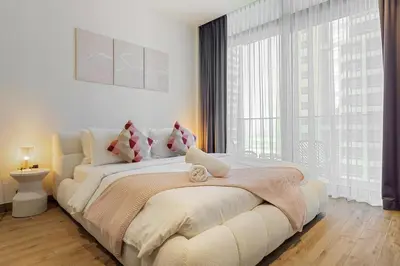 a bedroom with a large bed and a large window at Modern 1BR in Dubai Marina near to Dubai Harbour in Dubai