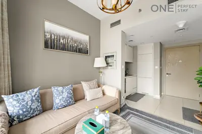 a living room with a couch and a table at Elegant 1BR in Business Bay with Pool & Gym in Dubai