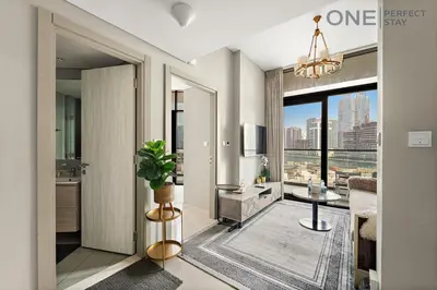 a living room with a view of a city at Elegant 1BR in Business Bay with Pool & Gym in Dubai