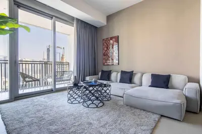 a living room with a couch and a large window at Frank Porter - 5242 Emaar Tower in Dubai